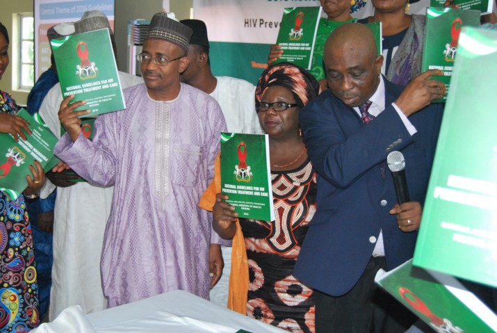 [Representative of the Hon. Minister of Health, Mr. Arioye Segilola (right), and Dr. Zipporah Kpamor, Country Representative for MSH with other dignitaries displaying the unveiled 2016 National Guidelines on HIV/AIDS in Kaduna State, Nigeria.] {Photo credit: Aor Ikyaabo, MSH}
