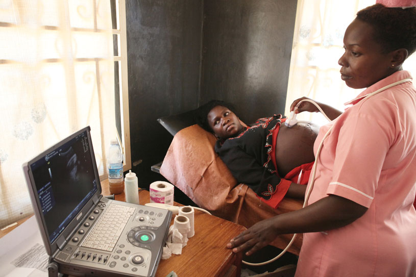 [A pregnant woman is given an ultrasound.] {Photo Credit: Rui Pires}