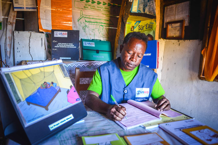 [Zafy André completes forms reporting community health data. CHVs are an integral part of Madagascar's health system and regularly submit community health data on malaria, which informs decisions and policy at the national level.]