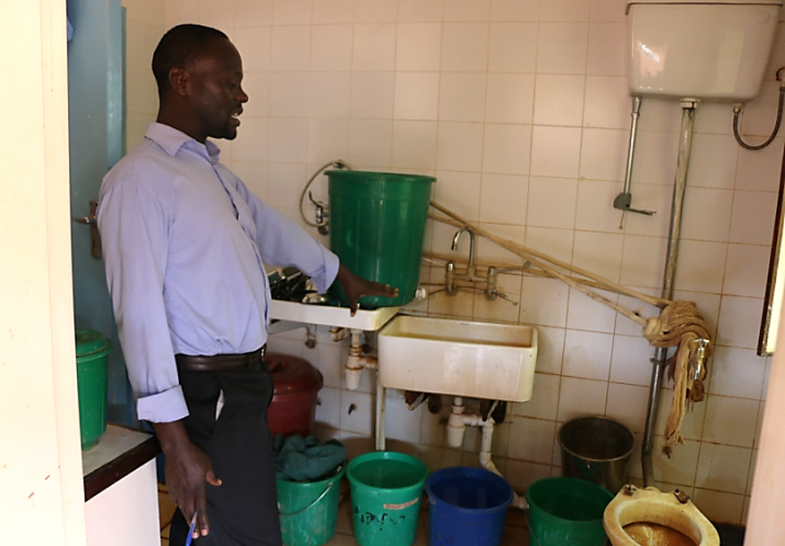 [Inspecting the water system at Mitundu Rural Hospital.]{Photo Credit: Chisomo Mdalla}