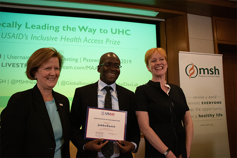 [Adama Kane, CEO of JokkoSanté presents his award with Marian W. Wentworth, President and CEO of MSH (left), and event moderator, Alix Peterson Zwane, CEO of the Global Innovation Fund (right). Photo credit: Sarah McKee/MSH]