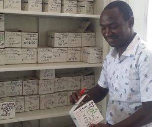 [Dr. Gemechu cross-checks doses taken and doses remaining on TB treatment patient kits at a health center in Oromia region to verify whether treatment is being delivered according to national guidelines.]