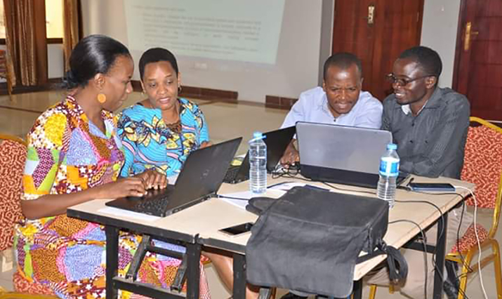 {MTaPS and MOH staff, and other stakeholders reviewing IPC standards. Photo credit: Christina Mchau}