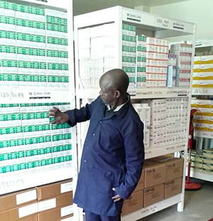 {Store Manager, Rueben Angole inside the Bundibugyo Hospital prefabricated medicine storage unit: Photo credit: UHSC staff/MSH}