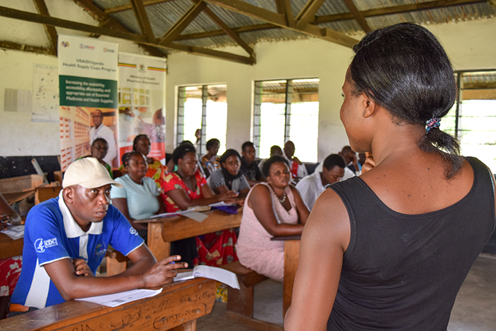 [Rebecca Kabugho, Nursing Officer at Karugutu Health Center, trains Village Health Teams (VHTs) on how to use the medicines consumption log. Photo credit MSH]