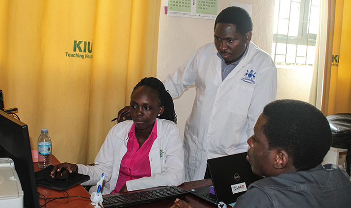 [Pharmacists at KIU Teaching Hospital view data in the Pharmaceutical Information Portal] {Photo credit: MSH staff}