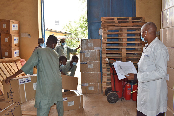 {Zamfara State warehouse manager observes as workers load the medicines used for seasonal malaria chemoprevention into trucks for last mile distribution. Photo credit: Dr. Sherifah Ibrahim/MSH}