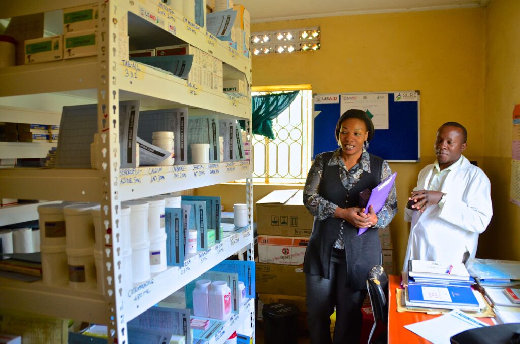 A medicines management supervisor visits pharmacy staff in Uganda