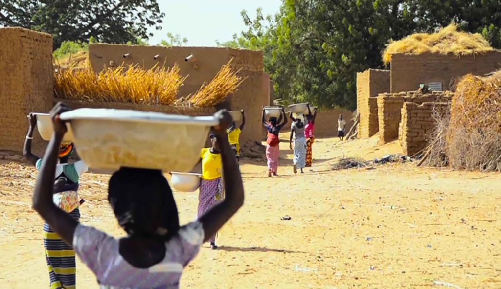 Women walking carrying bucket of harvest photo credit MSH