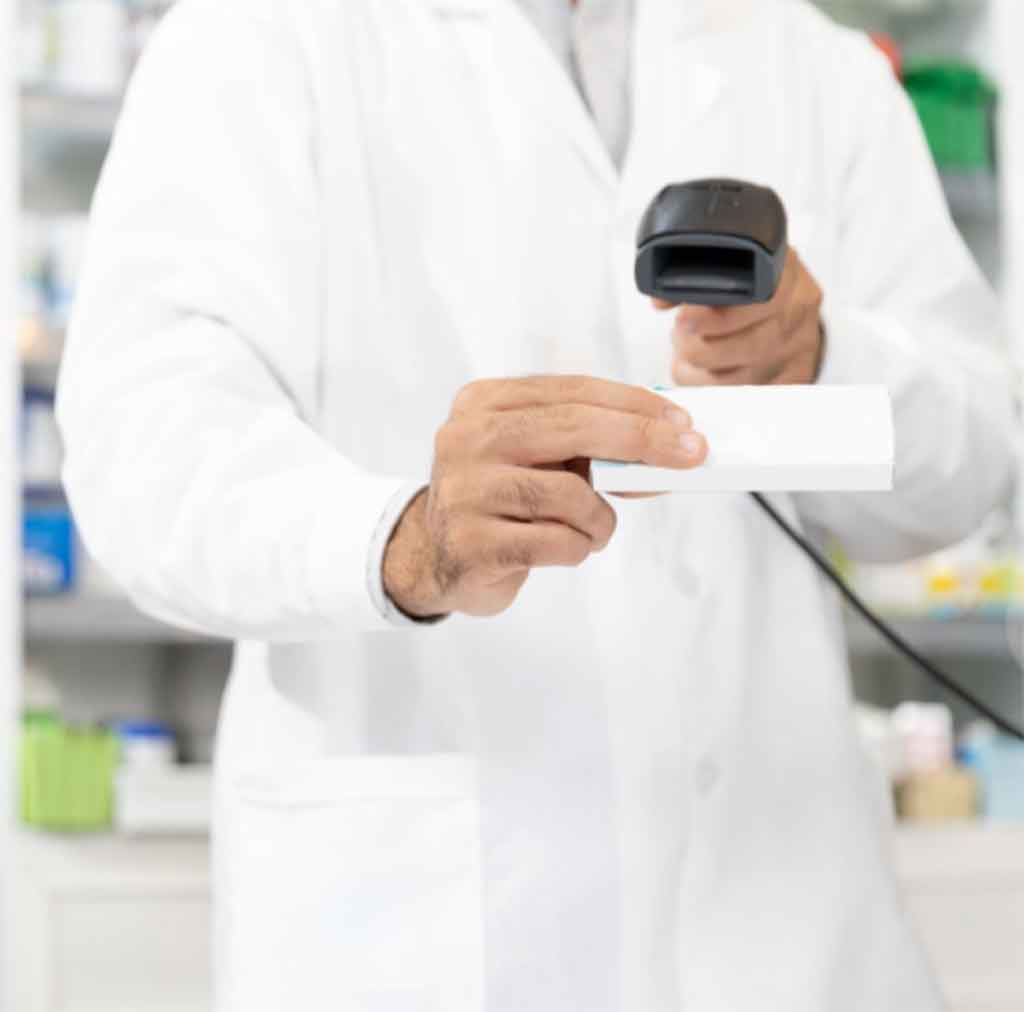 A pharmacist scans a health commodity bar code.