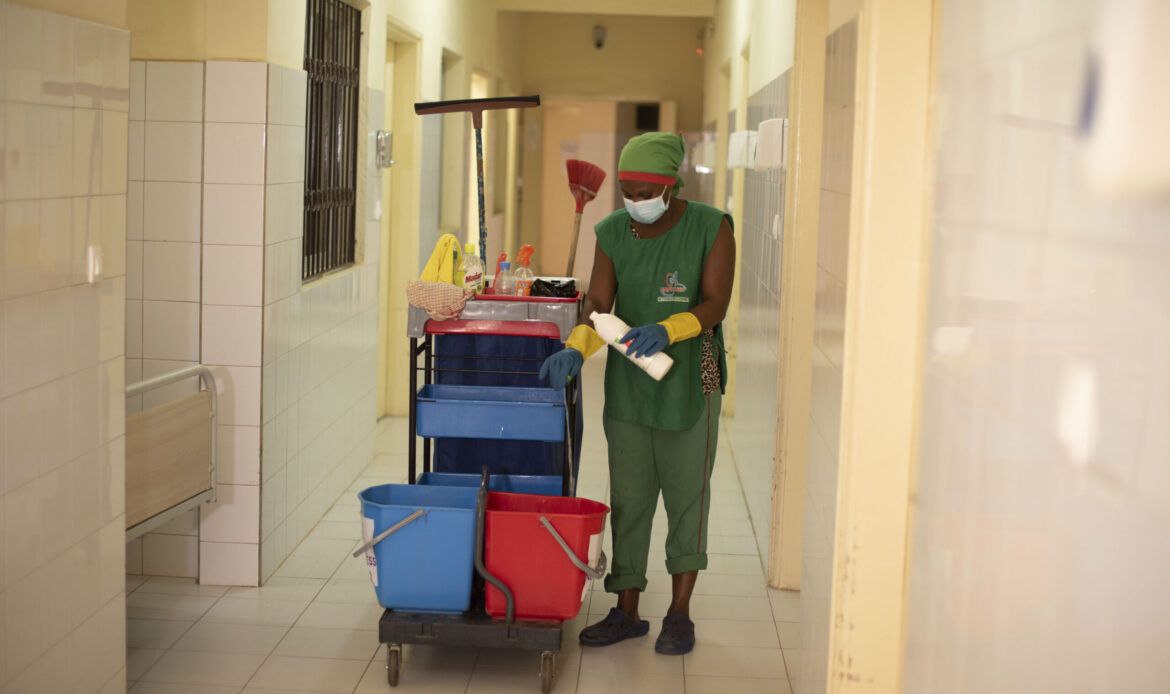 Box-4-Senegal-MTaPS-janitor-sterilizing-a-health-center-corridor-scaled alt