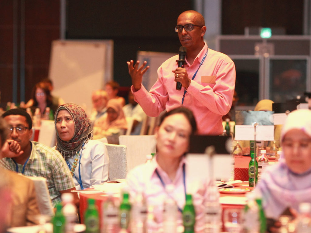 Man asks a question at a conference.