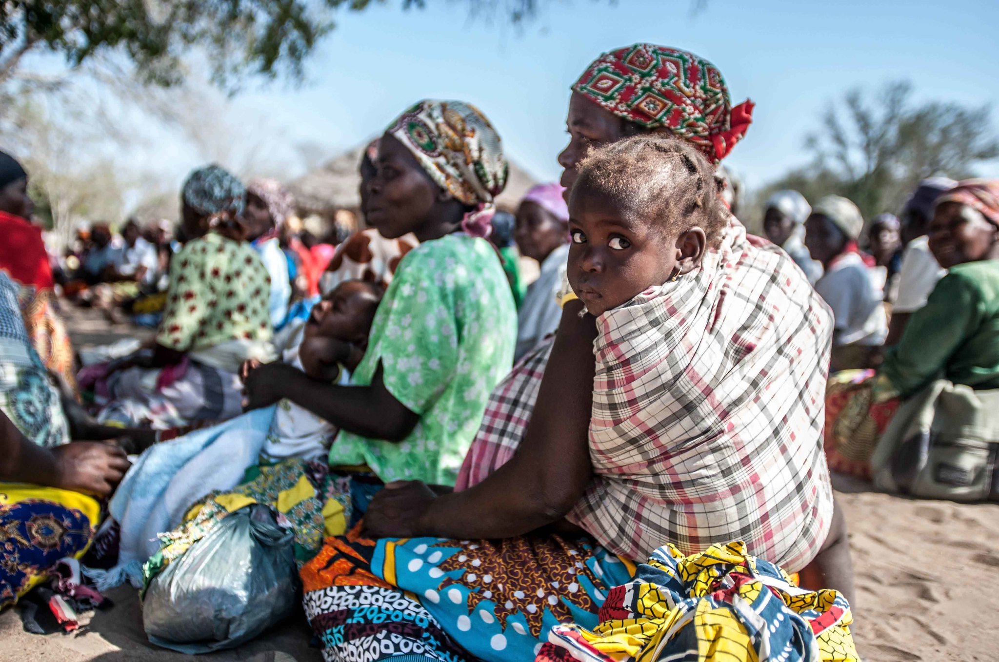 Mothers and children wait in Changanine community (Chibuto District), Mozambique to collect their seeds from the Red Cross. The community has been hit very hard by the current drought, many have lost their crops and locals have to walk up to five kilometres to dig for water (Photo: Aurélie Marrier d'Unienville / IFRC). Creative Commons License