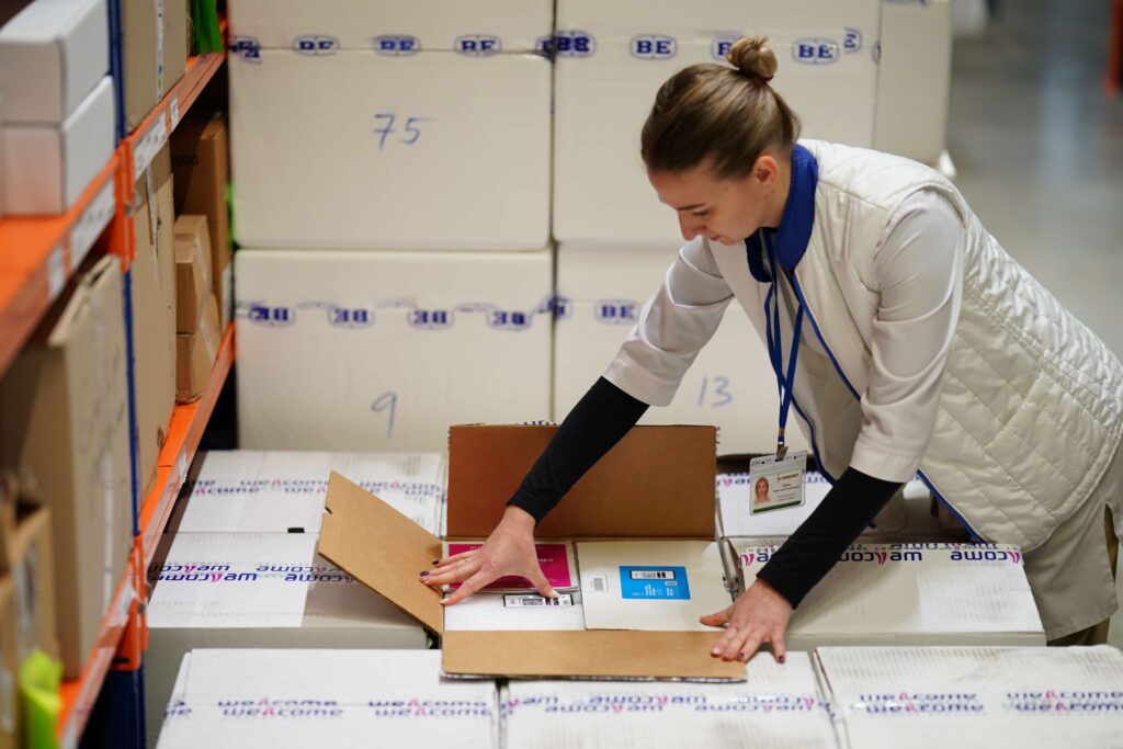 A worker checks a box at a Ukrainian pharmaceutical warehouse, Ukraine. Photo Credit: Farmasoft