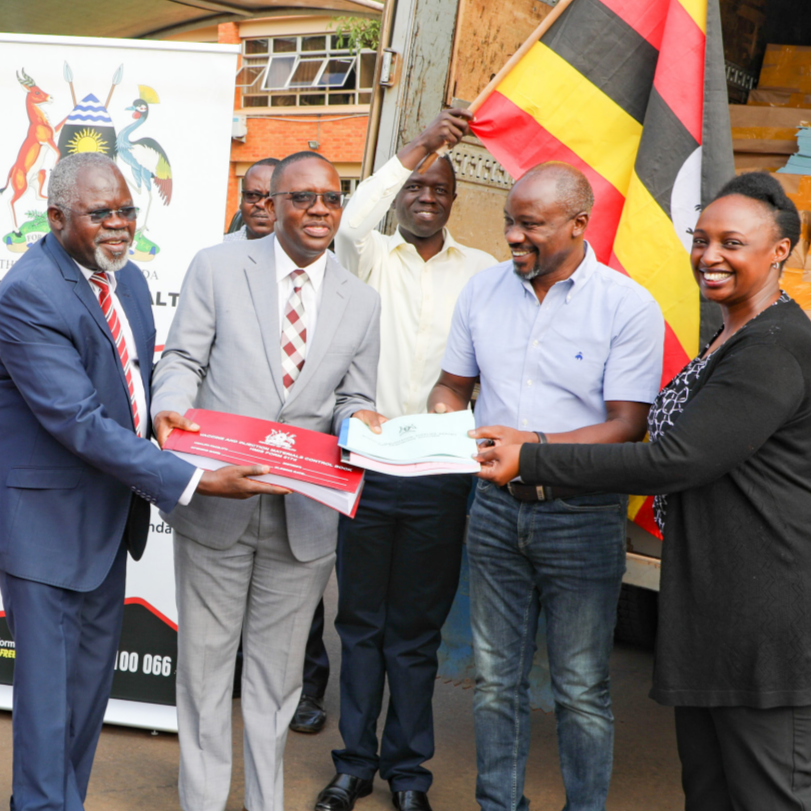 William Musubire (NMS), Dr. Ajulong Martha (AC DPNM), Dr. Driwale Alfred ( PM UNEPI), Dr. Daniel Kyabayinze (Director Public Health), Dr. Eric Lugada (CoP USAID/SSCS), Dr. Christine Mugasha (USAID) at the handover of COVID-19 Vaccination tools at the Ministry of Health Headquarters.