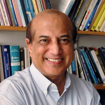 Headshot of Mushtaque Chowdhury in front of a bookcase
