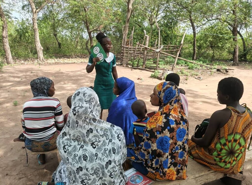 A health worker in North Tongu, Ghana, speaks in front of a group of people