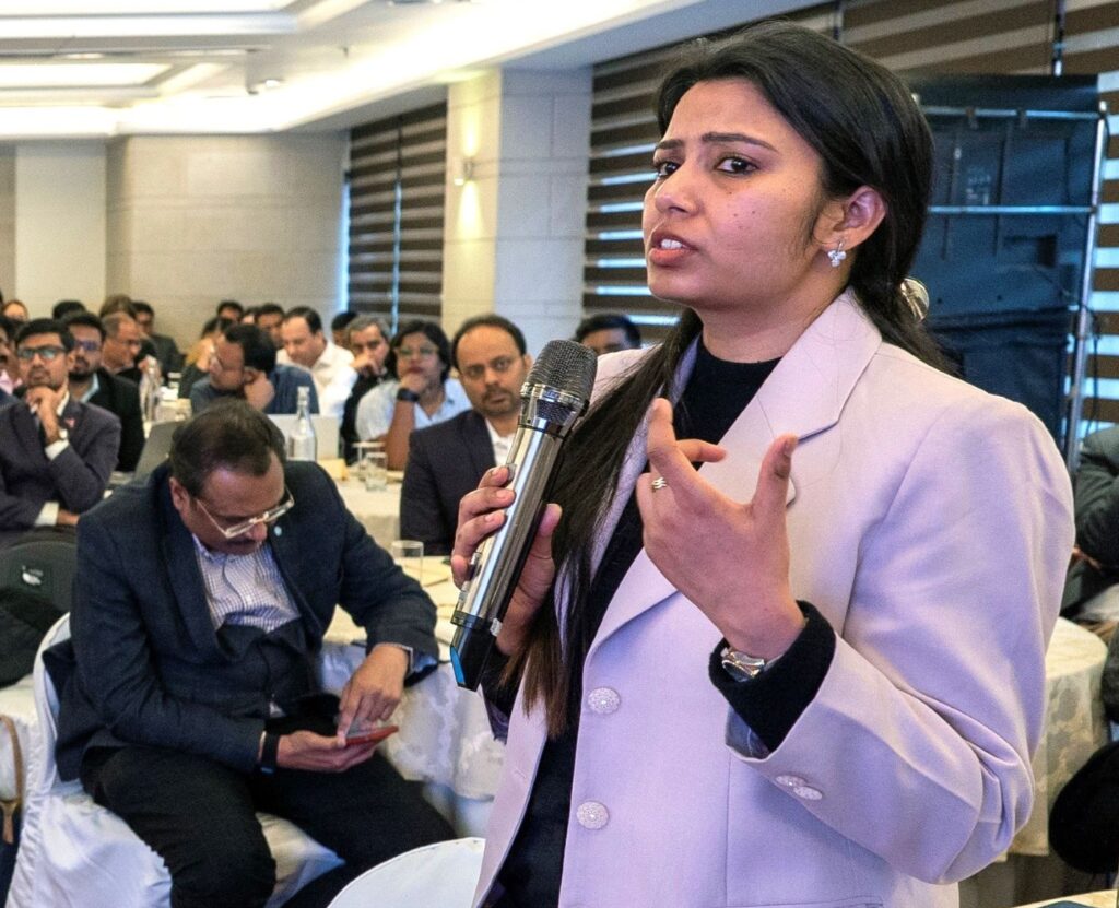 A woman speaks with passion holding a microphone to Nearly 150 representatives from 25 Indian states attended a two-day workshop in New Delhi this February on engaging the private sector in TB elimination. The workshop was led by India’s Central TB Division, with support from MSH-led, USAID Health Systems for TB (HS4TB) project and the World Bank. Photo by HS4TB.