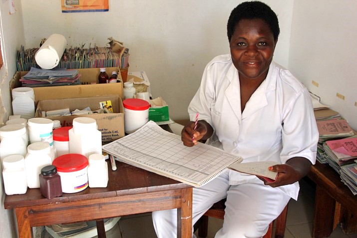 Cecilia tracks medication usage to prevent stock-outs of medicines and supplies at the Kiloleli Dispensary, Mwanza, Tanzania.