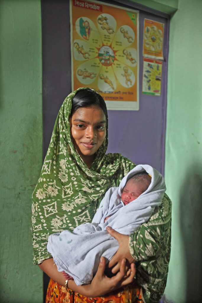 A young Bangladeshi mother holding her baby