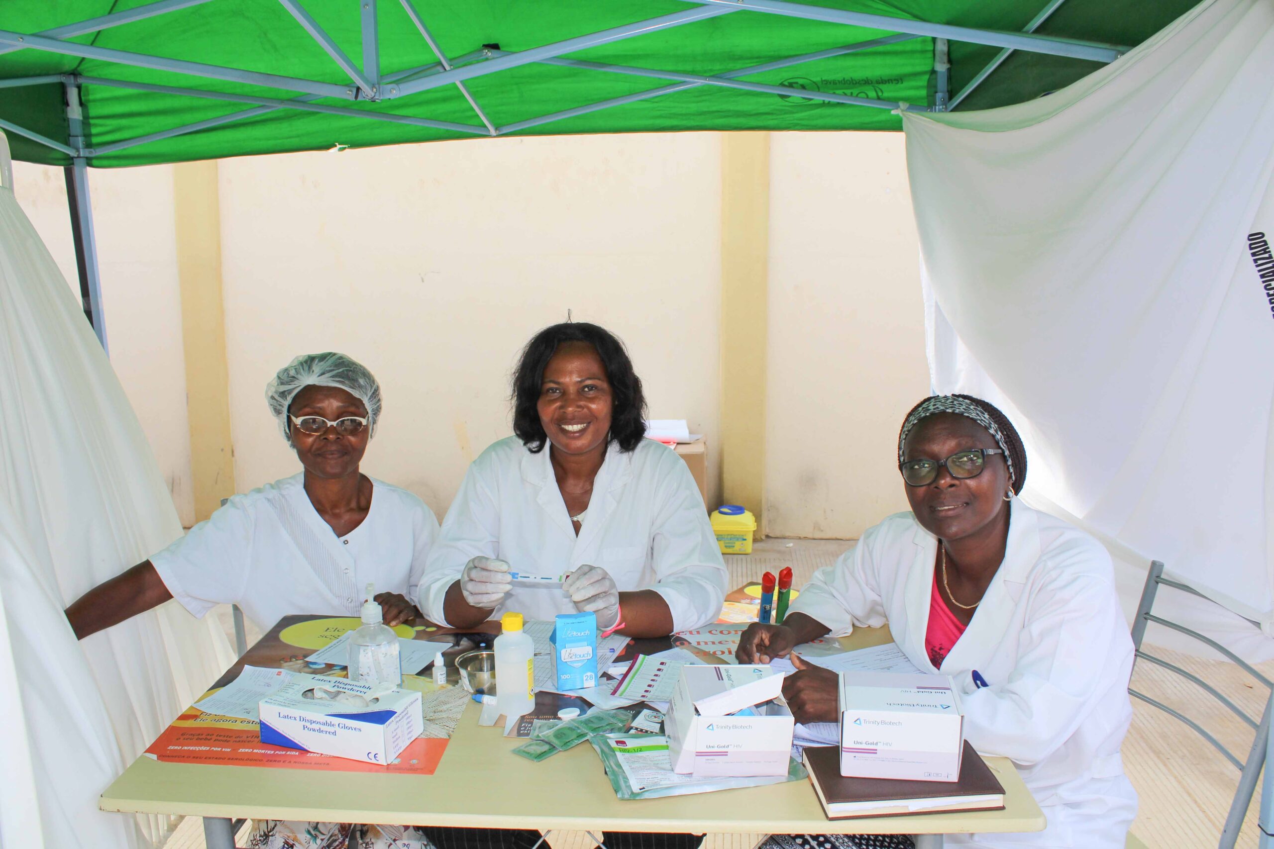 Three nurses sitting down looking at the camera
