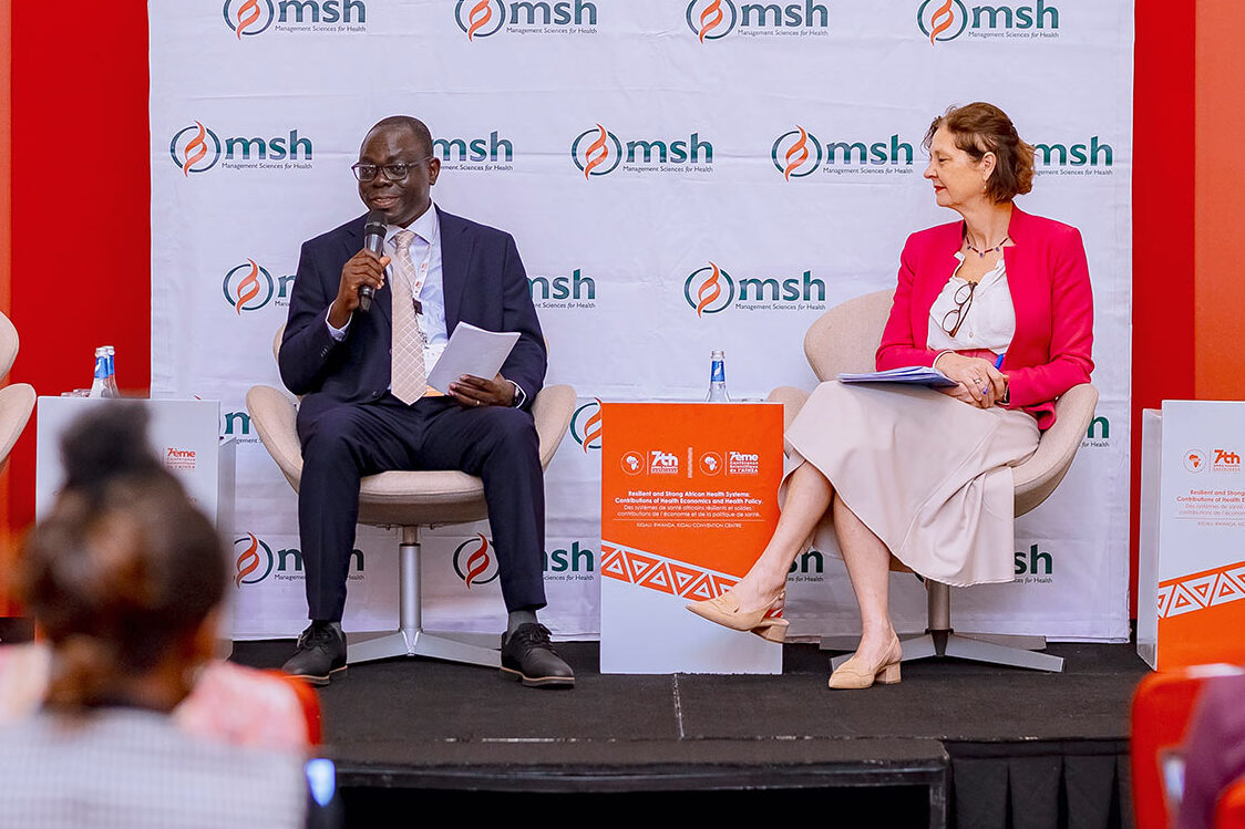 man and woman onstage at conference