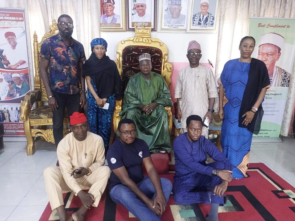 A group of eight people pose for a photo.
