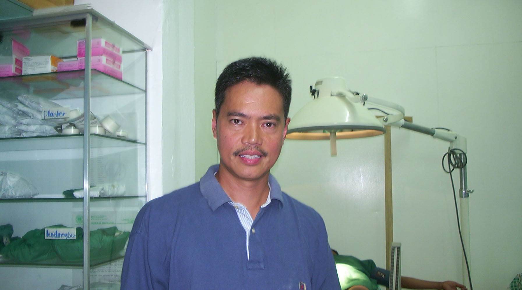 A man in a pharmacy looking at the camera