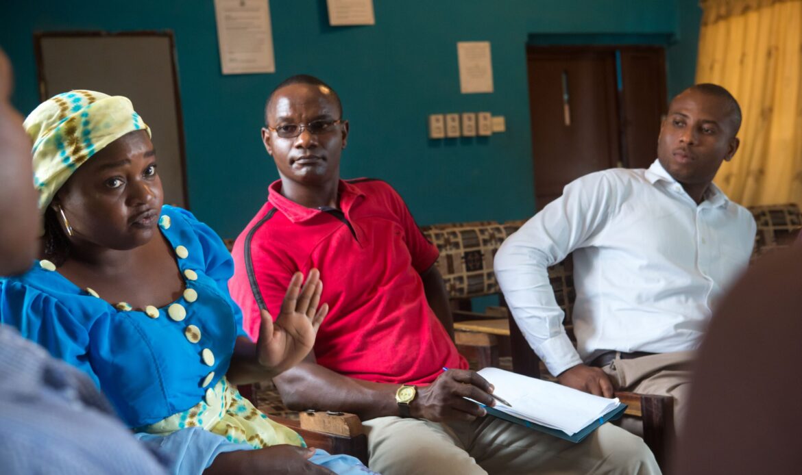 Nigeria_Header_Nigerian-government-health-facilities-staff-attend-a-meeting-about-Prevention-of-Mother-to-Child-Transmission-of-HIV-photo-by-Gwenn-Dubourthournieu-scaled alt