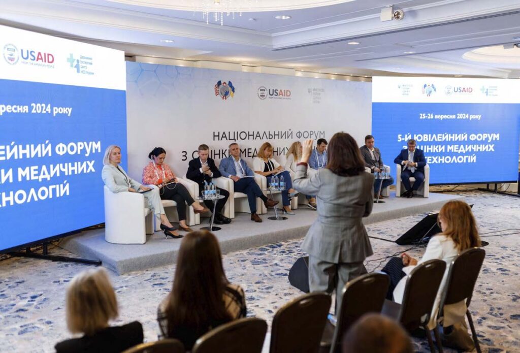 A group of people on stage during a live discussion.