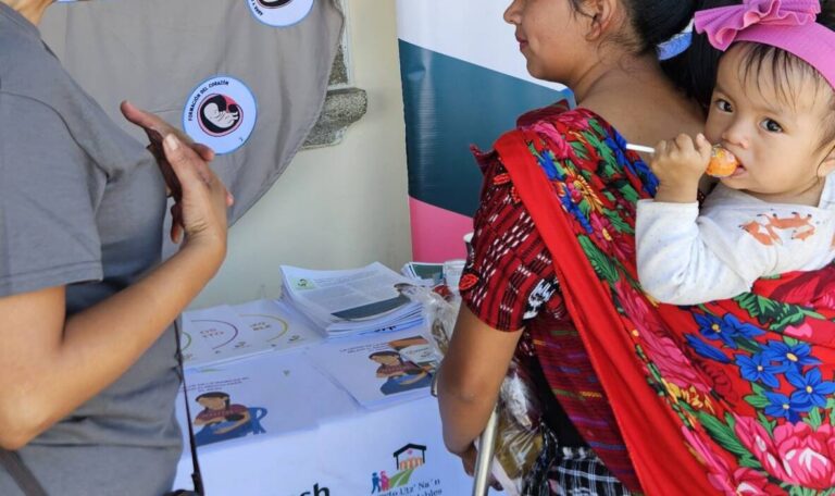 Two women at a maternal health event. One woman