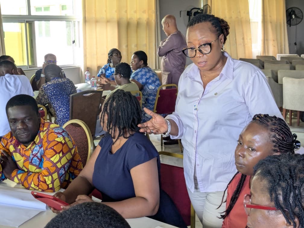 A woman leads a meeting in Ghana
