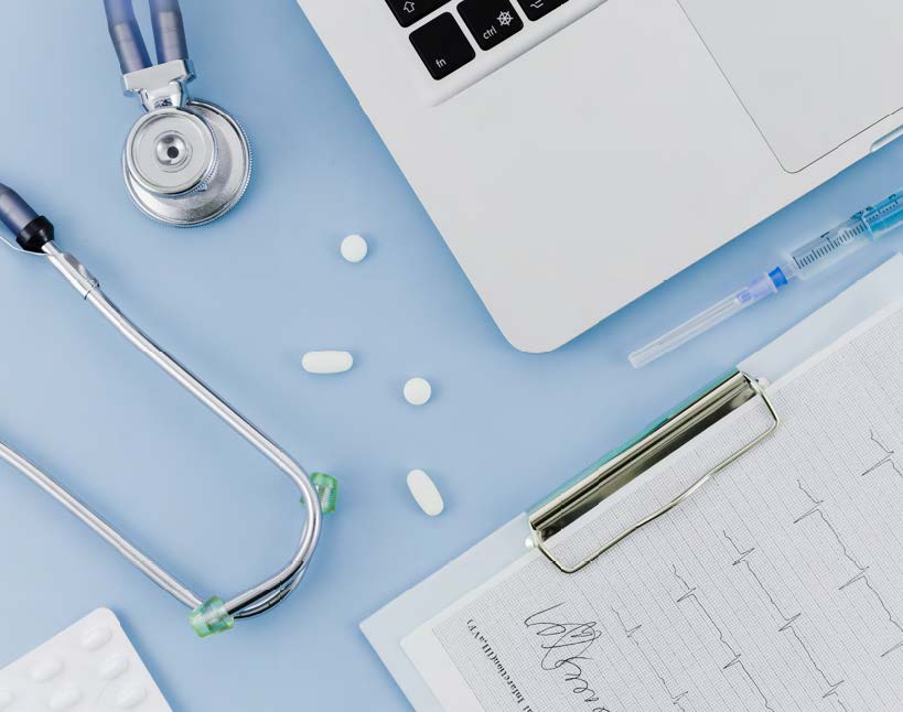 Top shot of various medical devices, chart, and laptop.