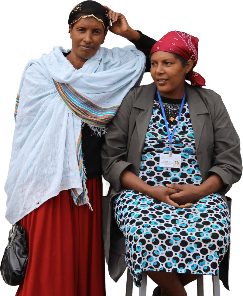 Two smiling health workers outside of a hospital in Ethiopia.