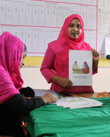 A young woman holding a training leaflet.