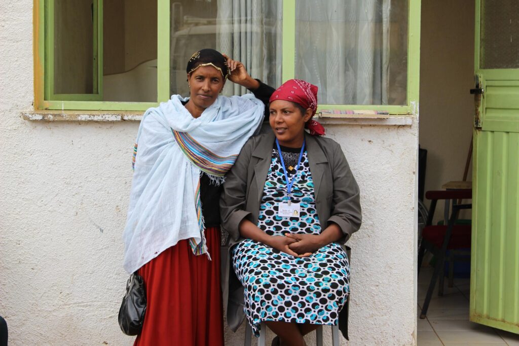 Two women standing in front of a building
