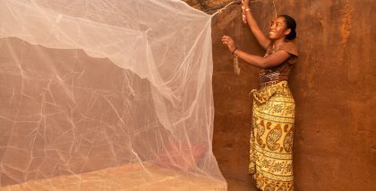 A-mother-installing-a-bednet_USAID-ACCESS-Program_Madagascar_photo-by-Samy-Rakotoniaina