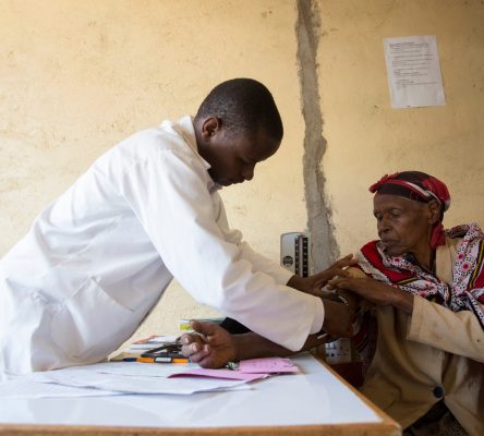 Doctor checking an elderly patient's blood pressure